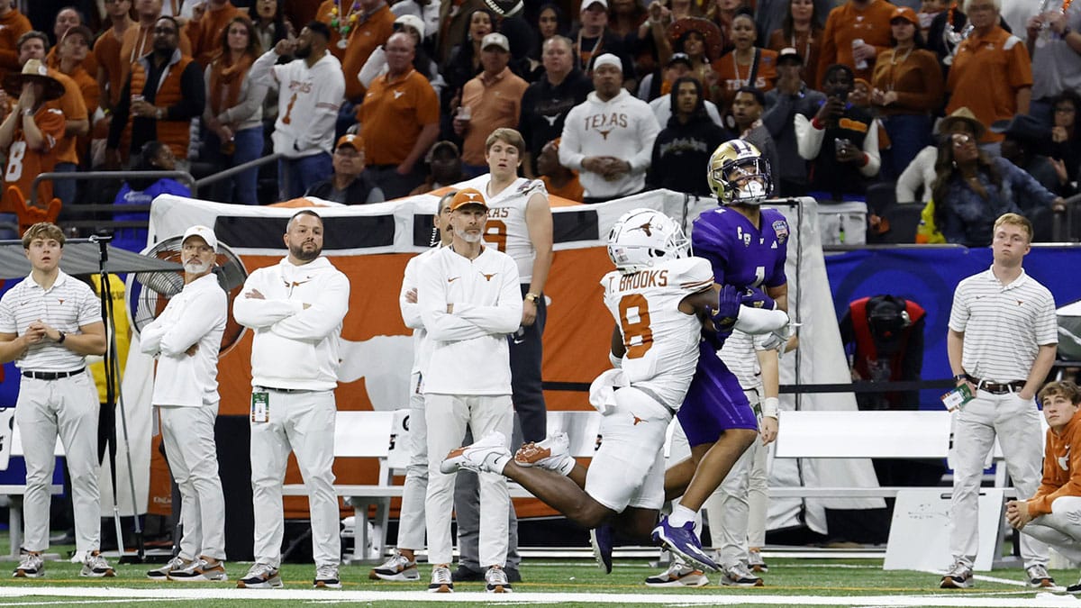 Texas Longhorns defensive back Terrance Brooks (8) is called for pass interference against Washington Huskies wide receiver Rome Odunze (1) during the fourth quarter of the 2024 Sugar Bowl college football playoff semifinal game at Caesars Superdome. 