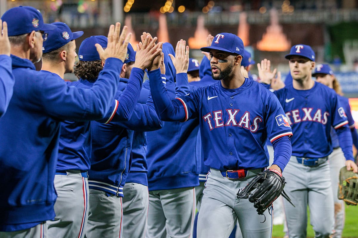 Texas Rangers outfielder Leody Taveras (3) high fives teammates after the game against the Kansas City Royals at Kauffman Stadium.