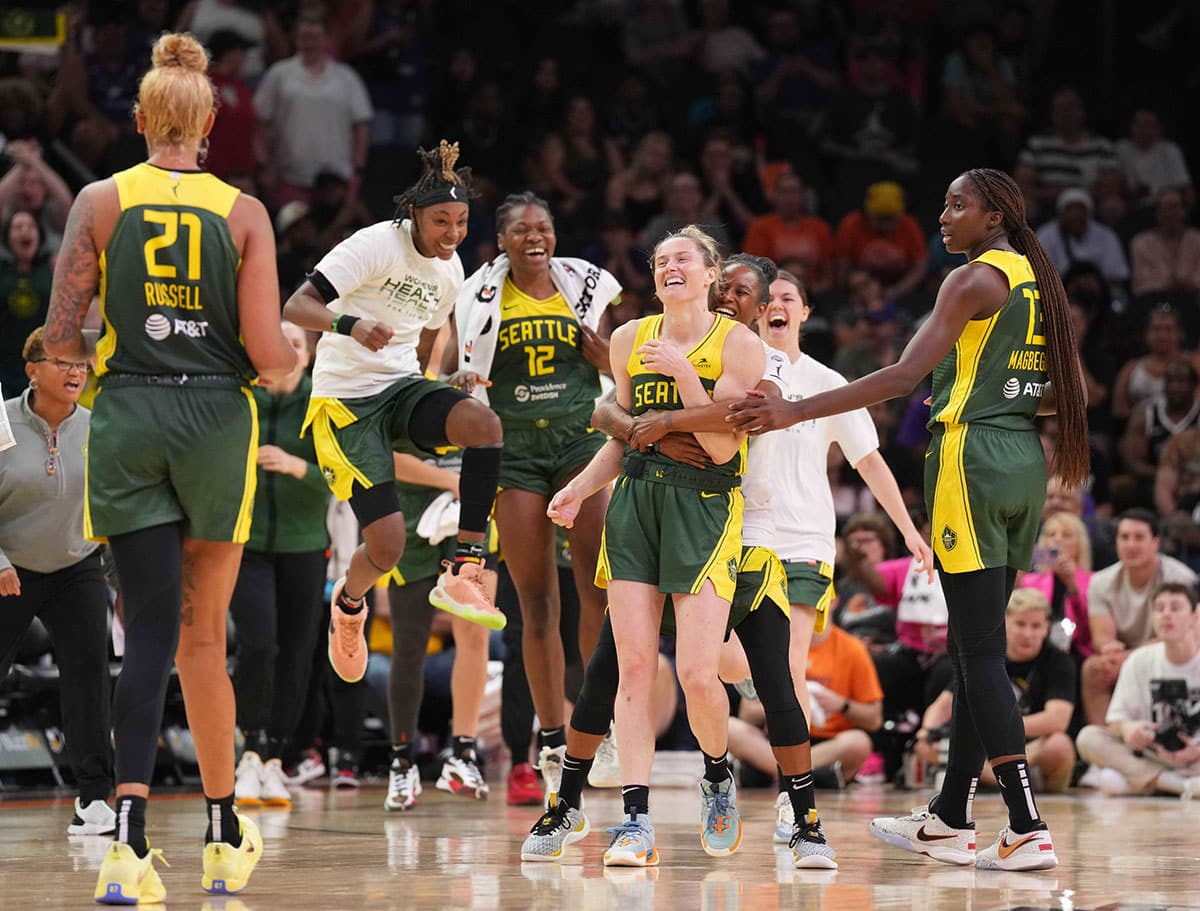 Seattle Storm guard Sami Whitcomb (32) celebrates with teammates after making a three point basket against the Phoenix Mercury during the second half.
