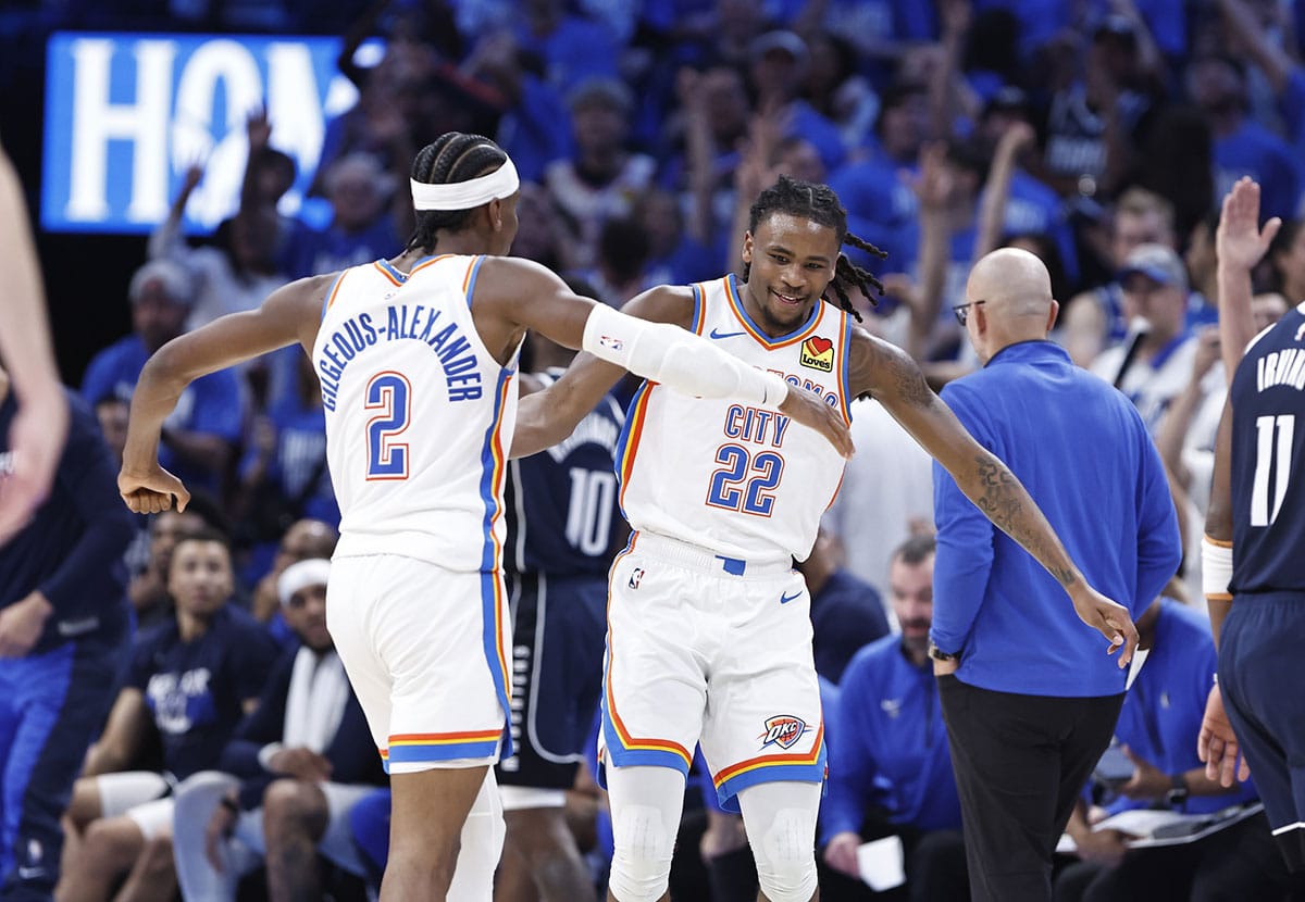 Oklahoma City Thunder guard Cason Wallace (22) celebrates with guard Shai Gilgeous-Alexander (2) after he scores a basket against the Dallas Mavericks during the second half of game one of the second round for the 2024 NBA playoffs at Paycom Center.