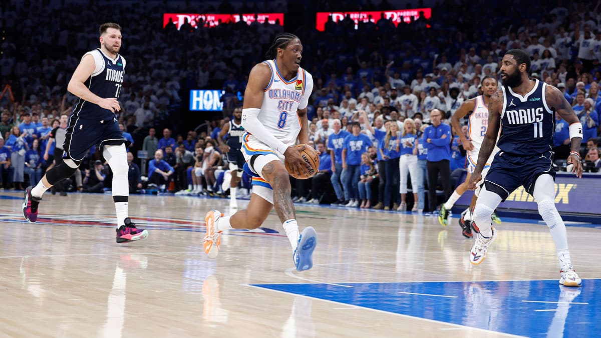 Oklahoma City Thunder forward Jalen Williams (8) drives to the basket between Dallas Mavericks guard Luka Doncic (77) and guard Kyrie Irving (11) during the second quarter of game one of the second round for the 2024 NBA playoffs at Paycom Center.