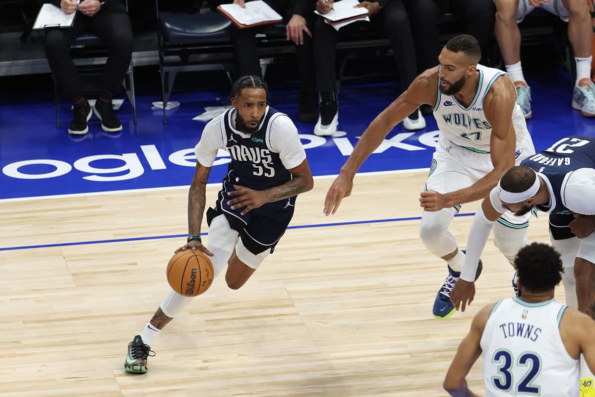 Dallas Mavericks forward Derrick Jones Jr. (55) controls the ball against Minnesota Timberwolves center Rudy Gobert (27) in the third quarter during game one of the western conference finals for the 2024 NBA playoffs at Target Center. 