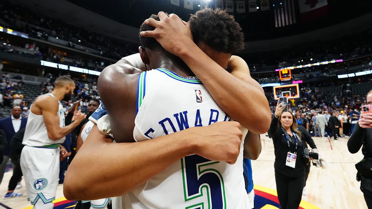 Minnesota Timberwolves center Karl-Anthony Towns (32) and guard Anthony Edwards (5) celebrate defeating the Denver Nuggets in game seven of the second round for the 2024 NBA playoffs at Ball Arena.