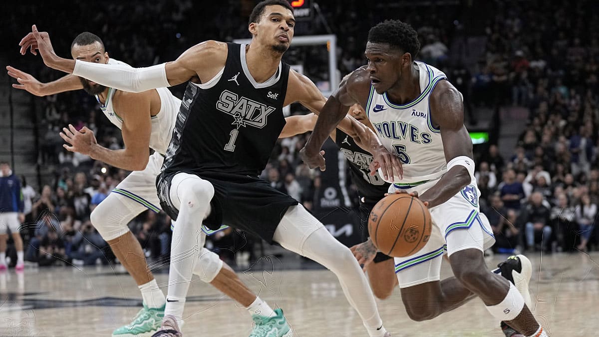 Timberwolves guard Anthony Edwards (5) drives to the basket against San Antonio Spurs forward Victor Wembanyama (1)