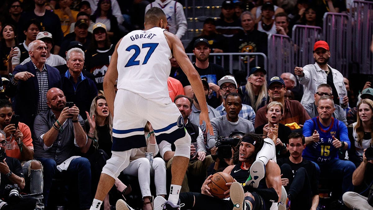 Denver Nuggets forward Aaron Gordon (50) gets tied up with Minnesota Timberwolves center Karl-Anthony Towns (32) as center Rudy Gobert (27) looks on in the second quarter during game five of the second round for the 2024 NBA playoffs at Ball Arena