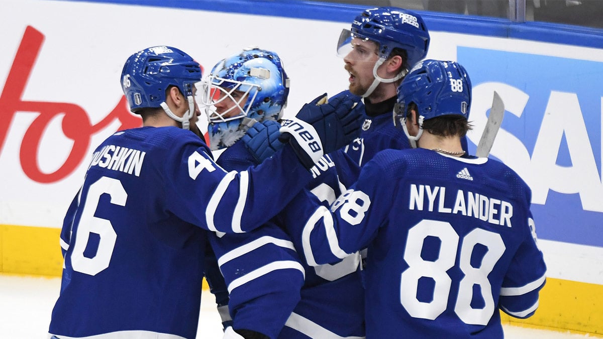 Toronto Maple Leafs goalie Joseph Woll (60) celebrates with defensemen Ilya Lyubushkin (46), Simone Benoit (2) and forward William Nylander after a win over the Boston period in game six of the first round of the 2024 Stanley Cup Playoffs at Scotiabank Arena.