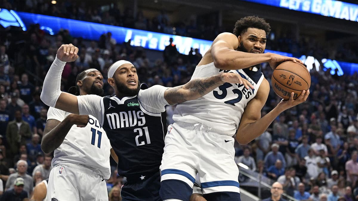 Minnesota Timberwolves center Karl-Anthony Towns (32) controls the ball against Dallas Mavericks center Daniel Gafford (21) in the second half during game three of the western conference finals for the 2024 NBA playoffs at American Airlines Center. 