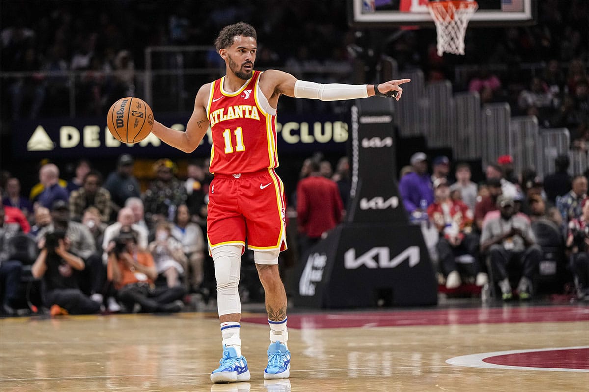 Atlanta Hawks guard Trae Young (11) points to a teammate against the Charlotte Hornets during the first half at State Farm Arena.
