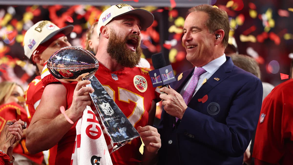 Travis Kelce holding the Lombardi Trophy after winning the Super Bowl