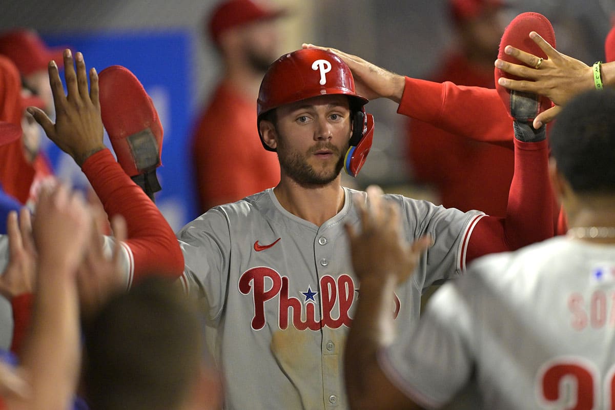 Philadelphia Phillies shortstop Trea Turner (7) is greeted in the dugout after he scored on a sacrifice fly by third baseman Alec Bohm (not pictured) in the ninth inning against the Los Angeles Angels at Angel Stadium.
