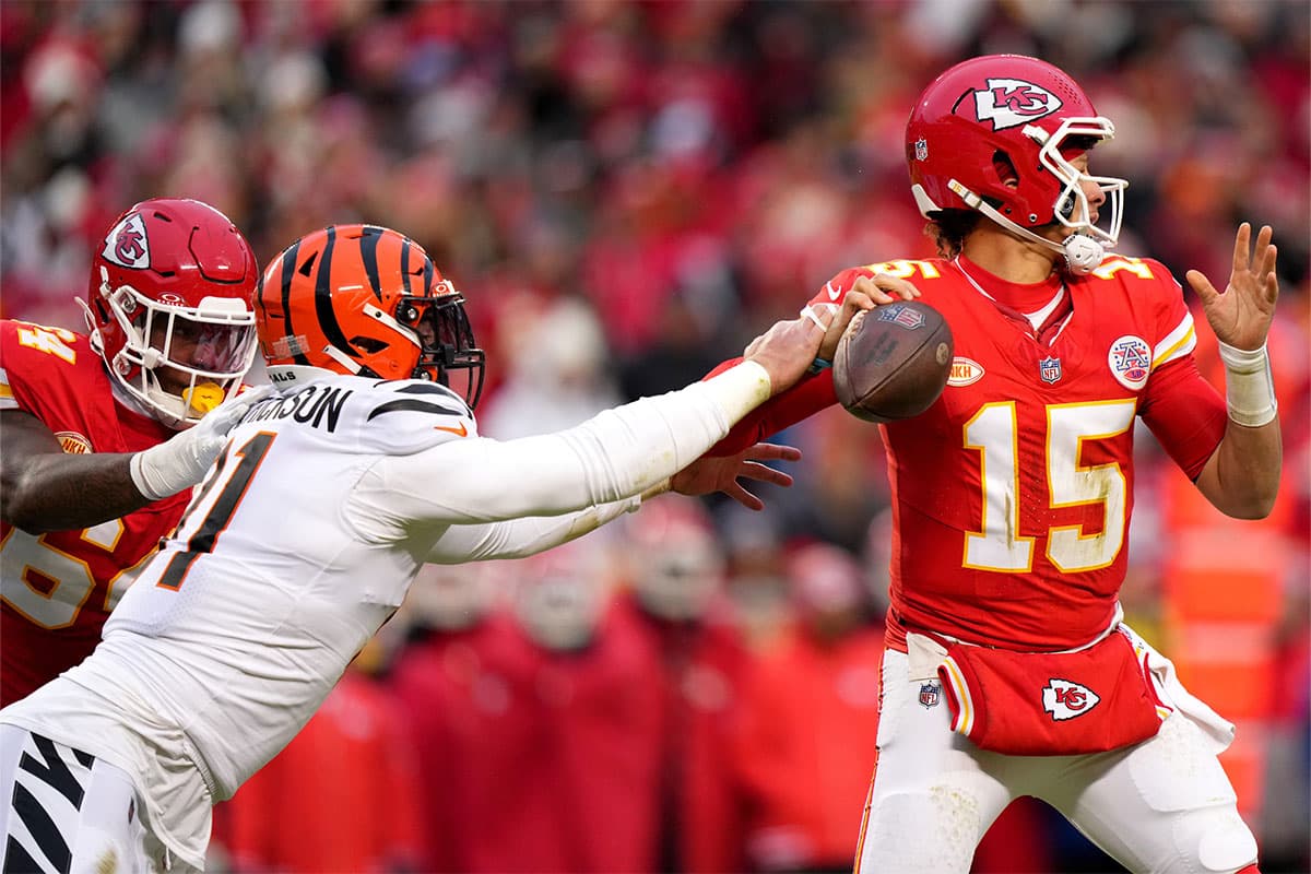 Cincinnati Bengals defensive end Trey Hendrickson (91) forces a fumble of Kansas City Chiefs quarterback Patrick Mahomes (15) in the second quarter during a Week 17 NFL football game between the Cincinnati Bengals and the Kansas City Chiefs at GEHA Field at Arrowhead Stadium.