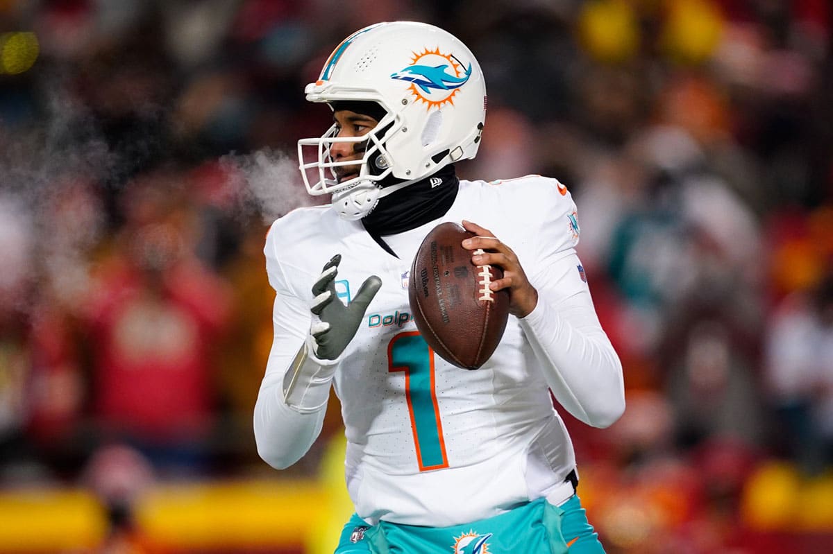 Miami Dolphins quarterback Tua Tagovailoa (1) drops back to pass against the Kansas City Chiefs during the first half of the 2024 AFC wild card game at GEHA Field at Arrowhead Stadium.