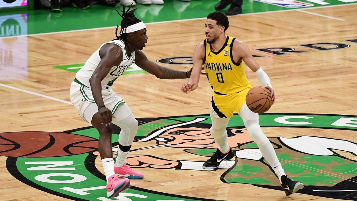 Indiana Pacers guard Tyrese Haliburton (0) dribbles the ball against Boston Celtics guard Jrue Holiday (4) in overtime for game one of the eastern conference finals for the 2024 NBA playoffs at TD Garden