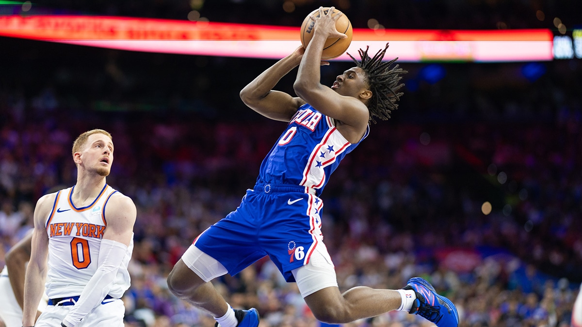Philadelphia 76ers guard Tyrese Maxey (0) drives for a shot in front of New York Knicks guard Donte DiVincenzo (0) during game six of the first round for the 2024 NBA playoffs at Wells Fargo Center.