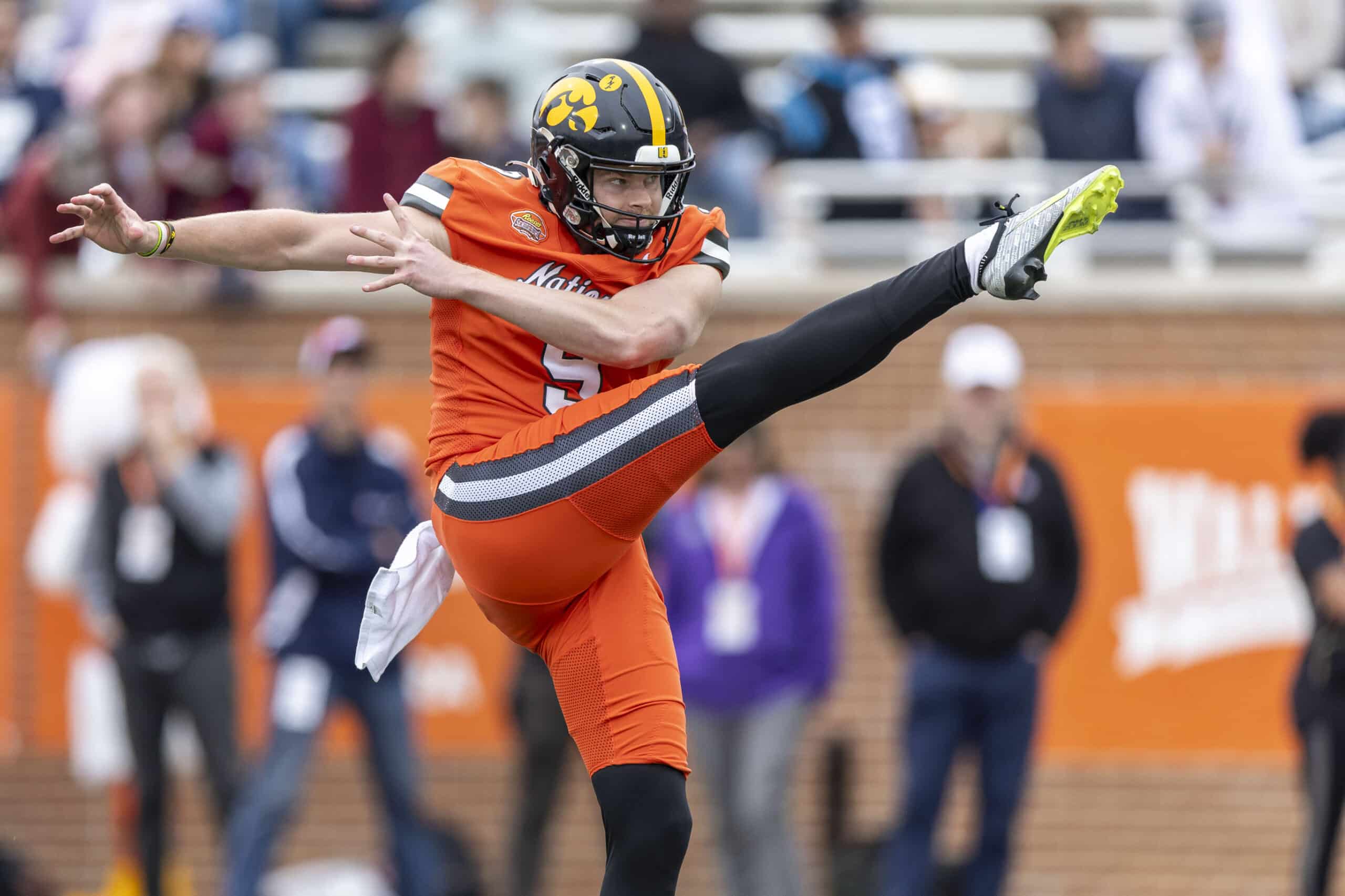 Feb 3, 2024; Mobile, AL, USA; National punter Tory Taylor of Iowa (9) punts during the first half of the 2024 Senior Bowl football game at Hancock Whitney Stadium. 