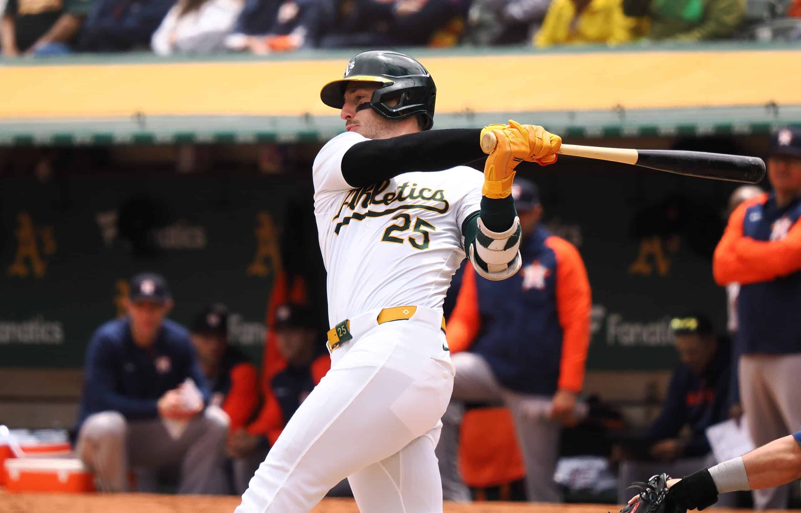 May 25, 2024; Oakland, California, USA; Oakland Athletics designated hitter Brent Rooker (25) hits an two-run RBI double against the Houston Astros during the first inning at Oakland-Alameda County Coliseum. 
