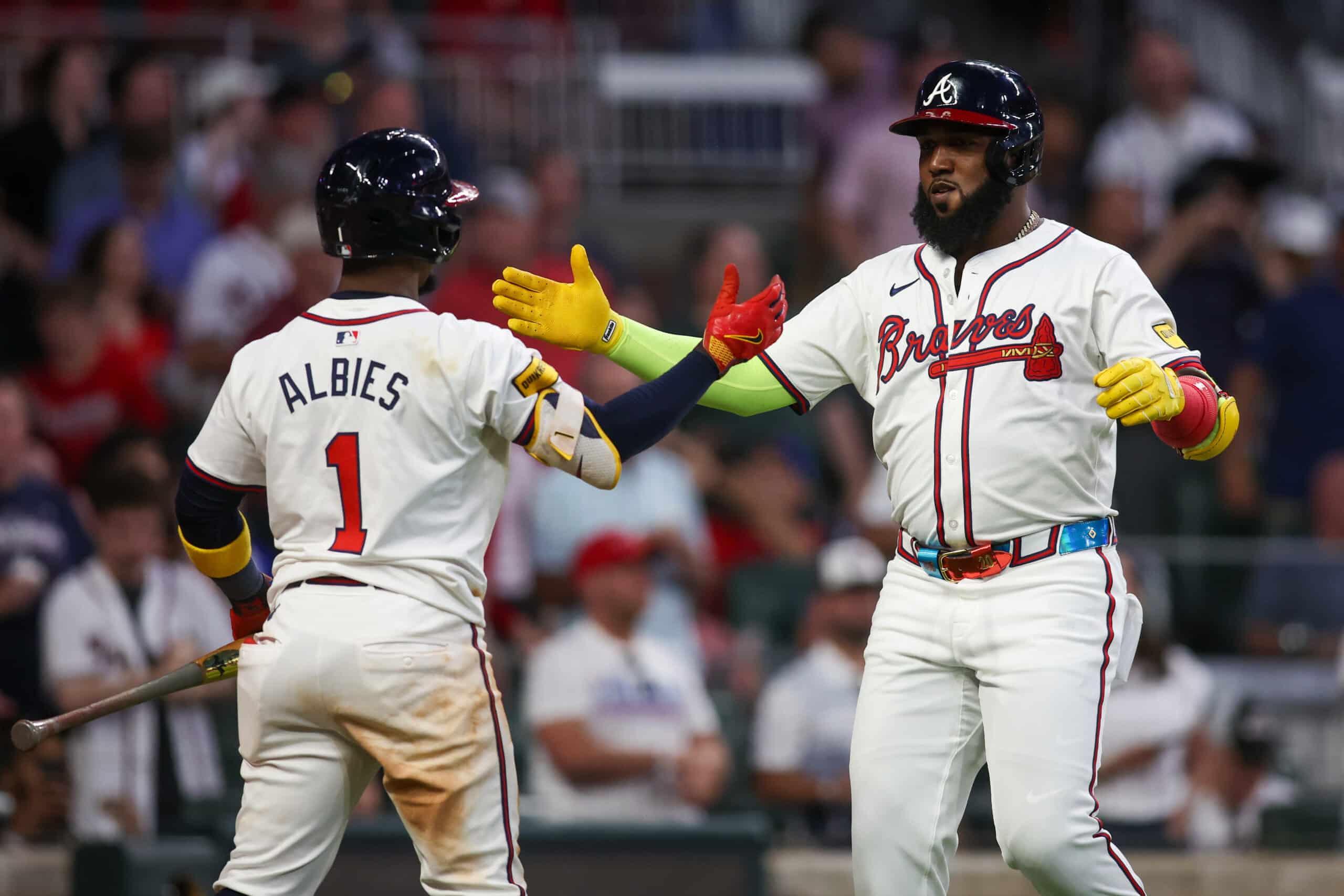 May 28, 2024; Atlanta, Georgia, USA; Atlanta Braves designated hitter Marcell Ozuna (20) celebrates after a home run with second baseman Ozzie Albies (1) against the Washington Nationals in the seventh inning at Truist Park. 