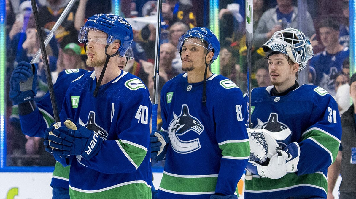 Vancouver Canucks forward Elias Pettersson (40) and forward Dakota Joshua (81) and goalie Arturs Silvos (31) wave to the crowd after the Edmonton Oilers win in game seven