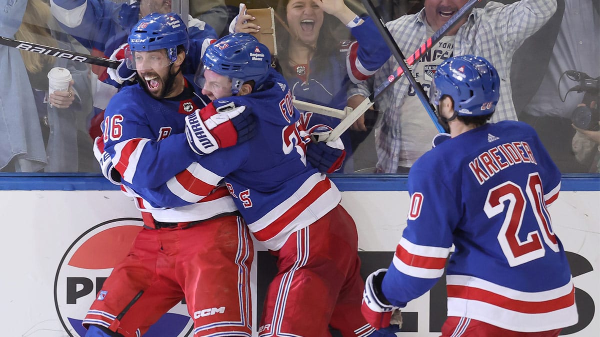 New York Rangers center Vincent Trocheck (16) celebrates his game winning goal against the Carolina Hurricanes with defenseman Adam Fox (23) and left wing Chris Kreider (20) during the second overtime of game two of the second round of the 2024 Stanley Cup Playoffs at Madison Square Garden