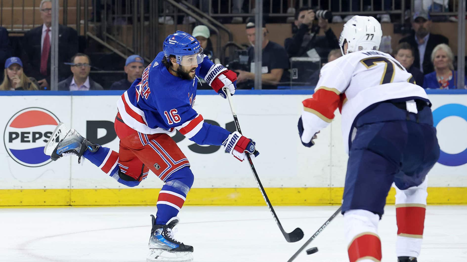 New York Rangers center Vincent Trocheck (16) takes a shot against Florida Panthers defenseman Niko Mikkola (77) during the first period of game one of the Eastern Conference Final of the 2024 Stanley Cup Playoffs at Madison Square Garden.