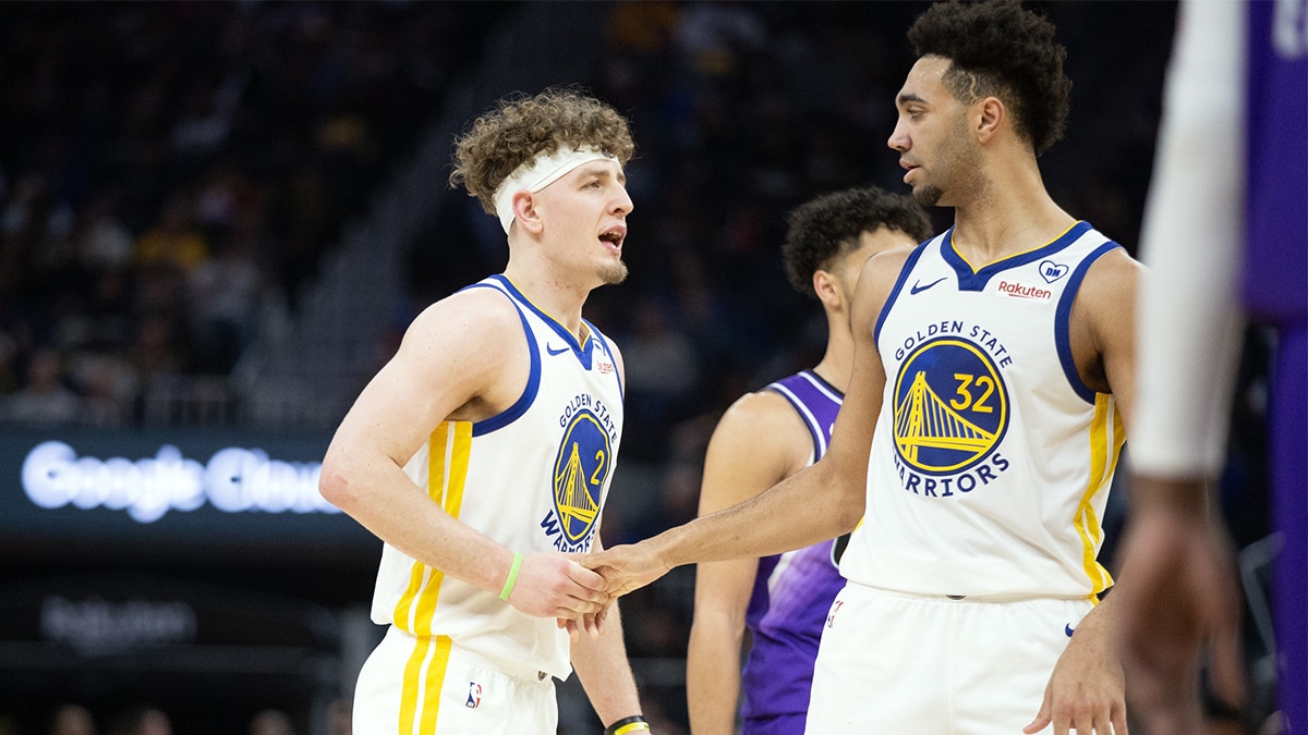 Golden State Warriors guard Brandin Podziemski (2) gets a congratulatory handshake from forward Trayce Jackson-Davis (32) after a made basket against the Utah Jazz during the second quarter at Chase Center. 