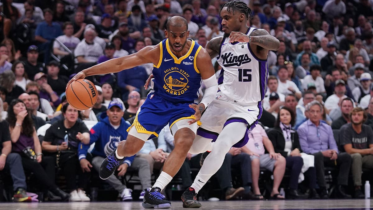 Golden State Warriors guard Chris Paul (3) dribbles the ball next to Sacramento Kings guard Davion Mitchell (15) in the second quarter during a play-in game of the 2024 NBA playoffs at the Golden 1 Center. 