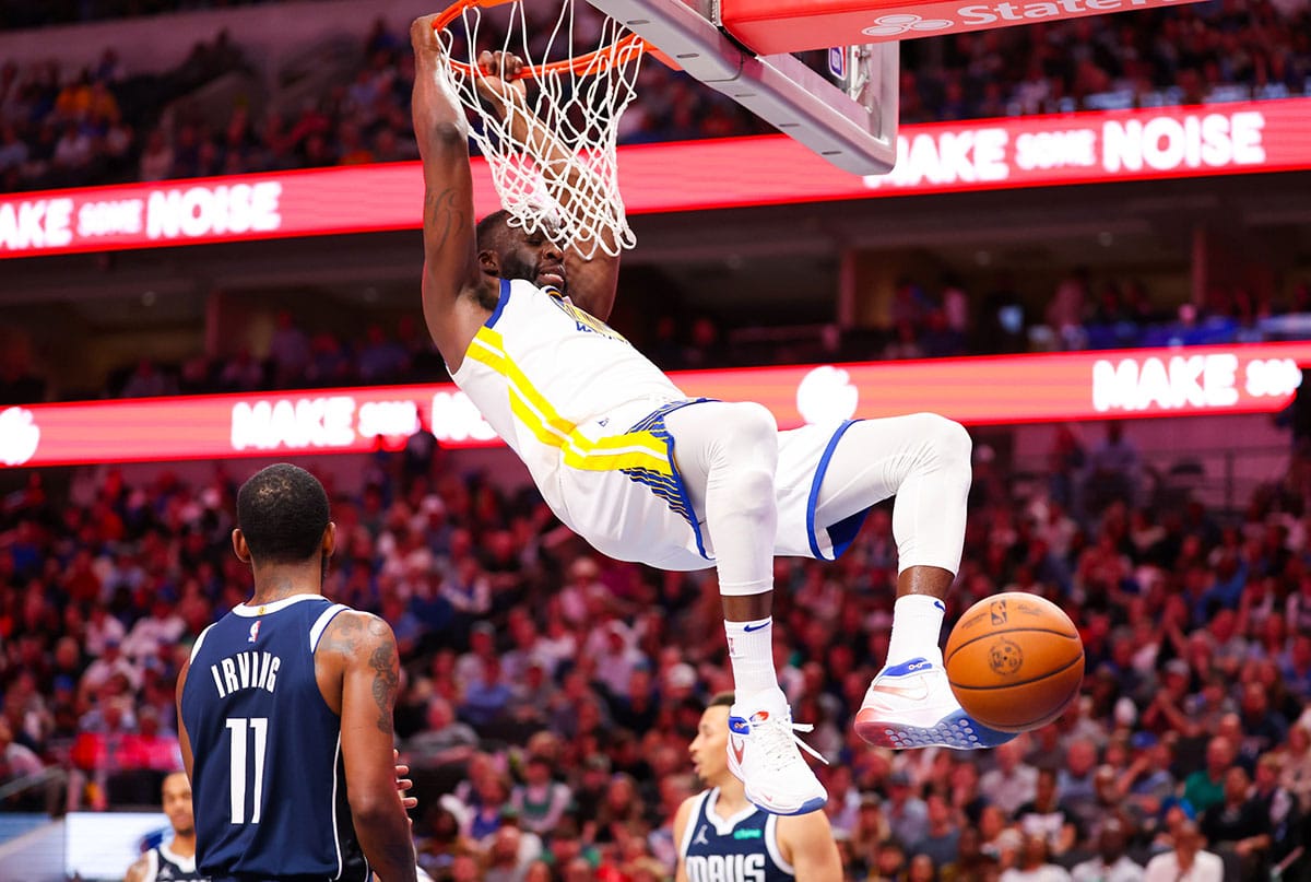 Golden State Warriors forward Draymond Green (23) dunks past Dallas Mavericks guard Kyrie Irving (11) during the second half at American Airlines Center.