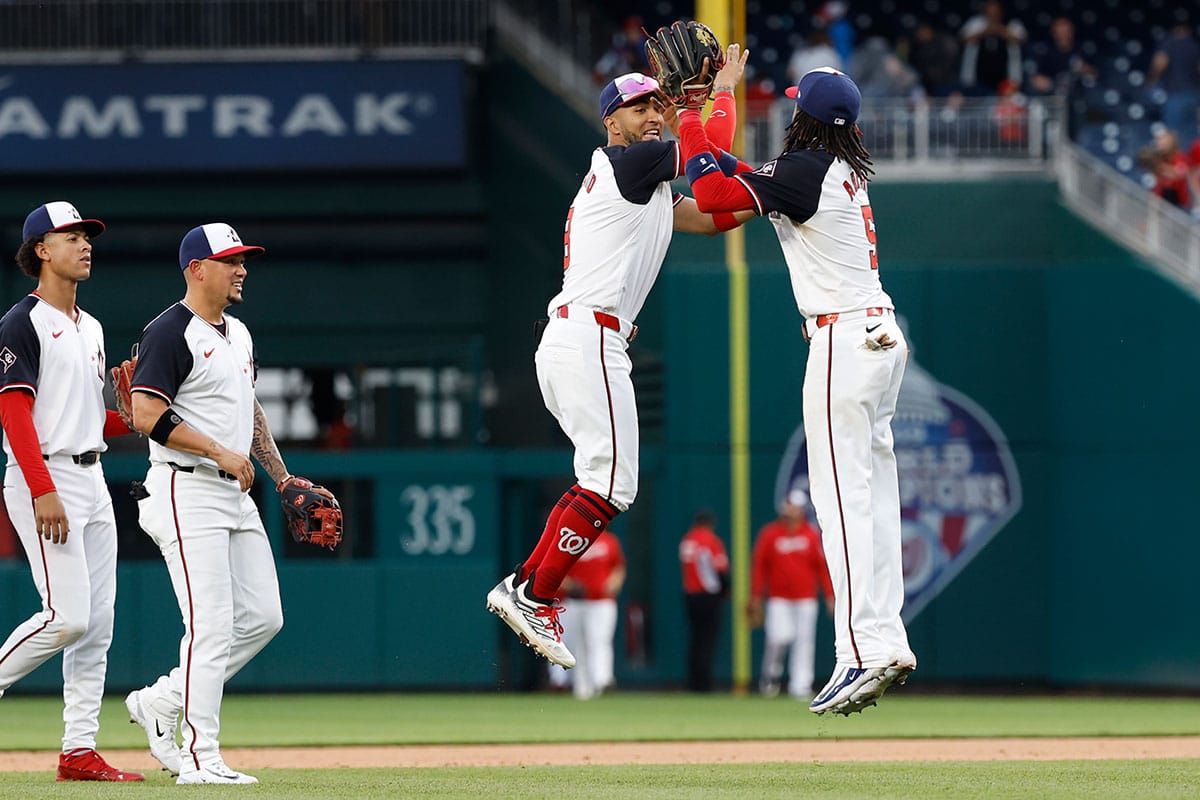 Washington Nationals outfielder Eddie Rosario (8) celebrates with Nationals shortstop CJ Abrams (5) after their game against the Toronto Blue Jays at Nationals Park. 