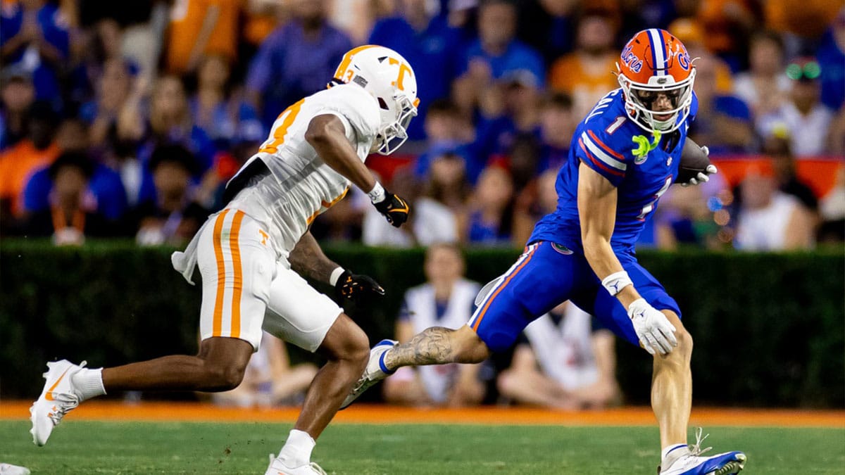 Florida Gators wide receiver Ricky Pearsall (1) runs away from Tennessee Volunteers defensive back Wesley Walker (13) during the first half at Ben Hill Griffin Stadium.