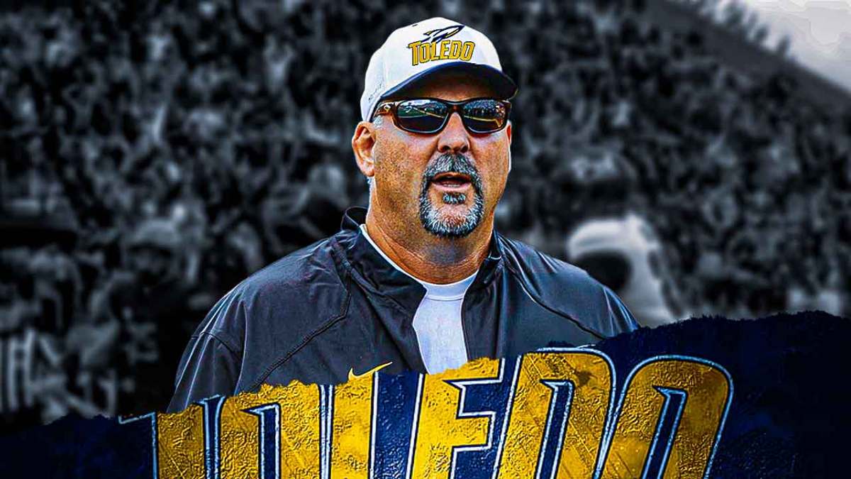 Toledo football's Craig Kuligoswki stands on field, discrimination lawsuit reporters in background