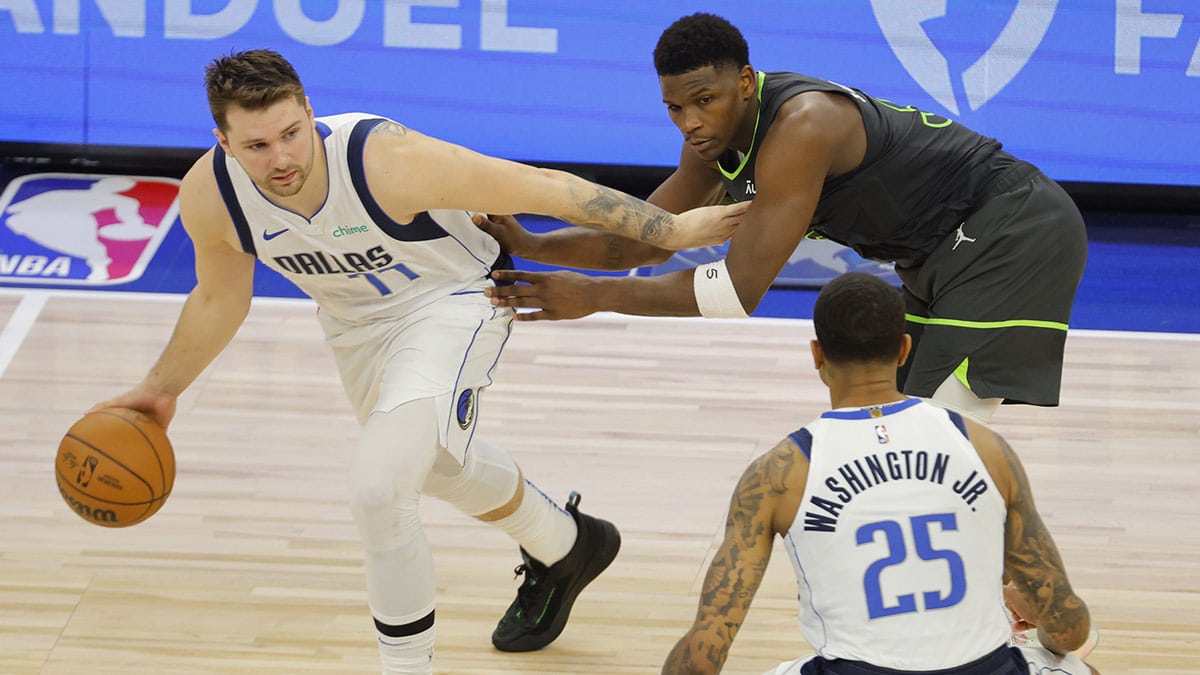 Dallas Mavericks guard Kyrie Irving (11) dribbles against Minnesota Timberwolves guard Anthony Edwards (5) during the second half in game five of the western conference finals for the 2024 NBA playoffs at Target Center. 