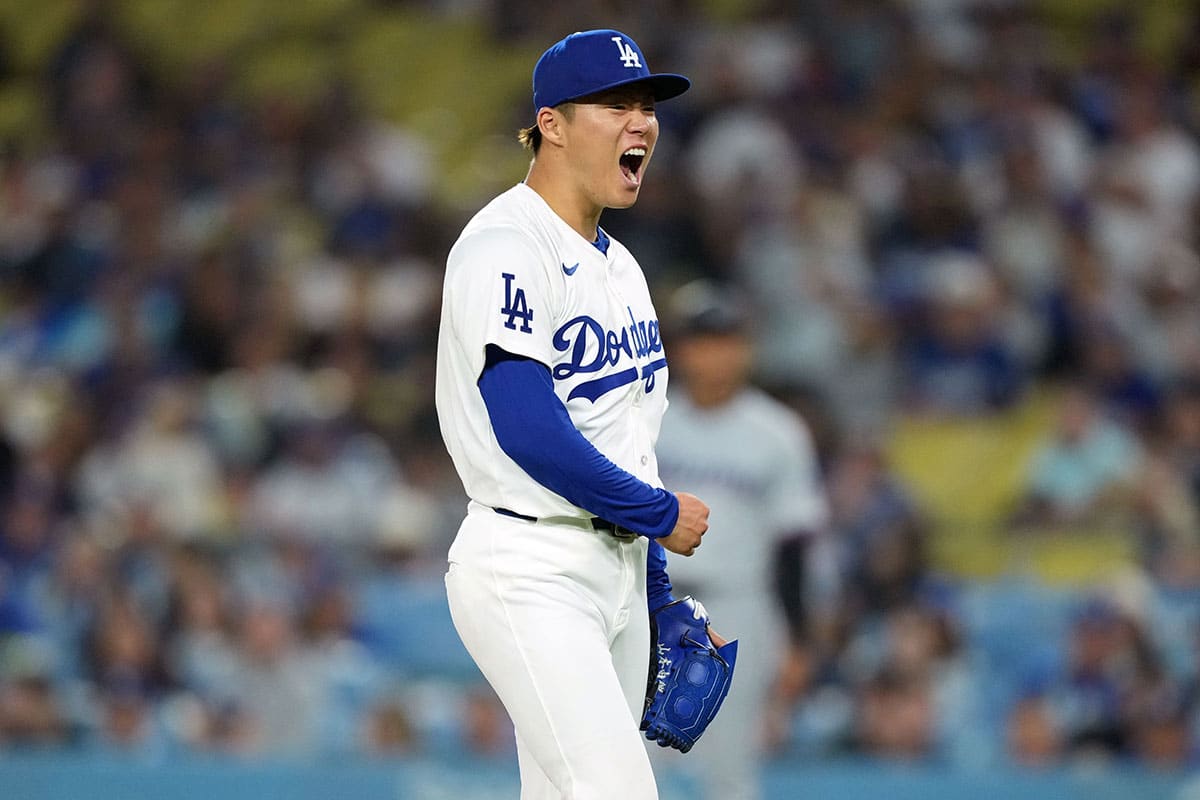 Los Angeles Dodgers pitcher Yoshinobu Yamamoto (18) celebrates at the end of the eighth inning against the Miami Marlins at Dodger Stadium.
