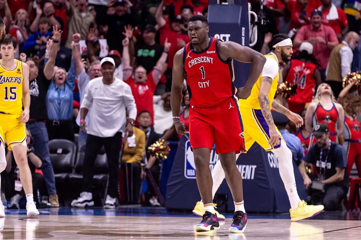 New Orleans Pelicans forward Zion Williamson (1) reacts to making a basket against Los Angeles Lakers forward Anthony Davis (3) during the second half of a play-in game of the 2024 NBA playoffs at Smoothie King Center.
