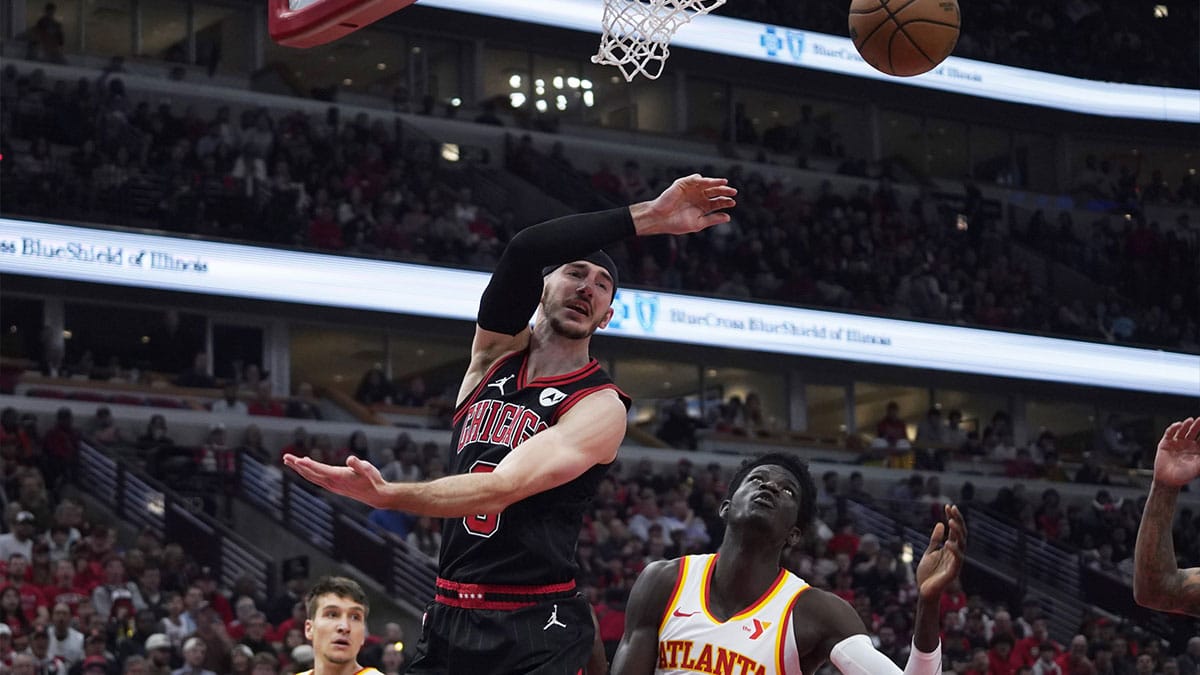 Apr 17, 2024; Chicago, Illinois, USA; Atlanta Hawks forward Mouhamed Gueye (18) defends Chicago Bulls guard Alex Caruso (6) during the first quarter during a play-in game of the 2024 NBA playoffs at United Center. Mandatory Credit: David Banks-USA TODAY Sports