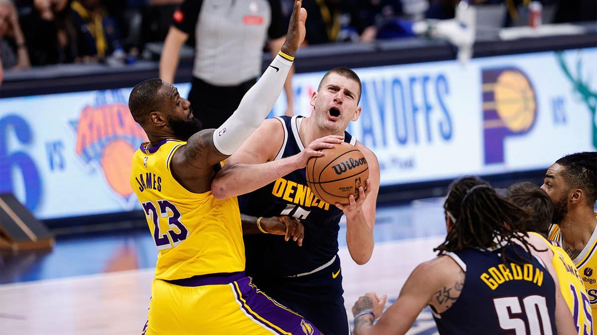 Apr 29, 2024; Denver, Colorado, USA; Denver Nuggets center Nikola Jokic (15) drives to the net against Los Angeles Lakers forward LeBron James (23) in the fourth quarter during game five of the first round for the 2024 NBA playoffs at Ball Arena. Mandatory Credit: Isaiah J. Downing-USA TODAY Sports