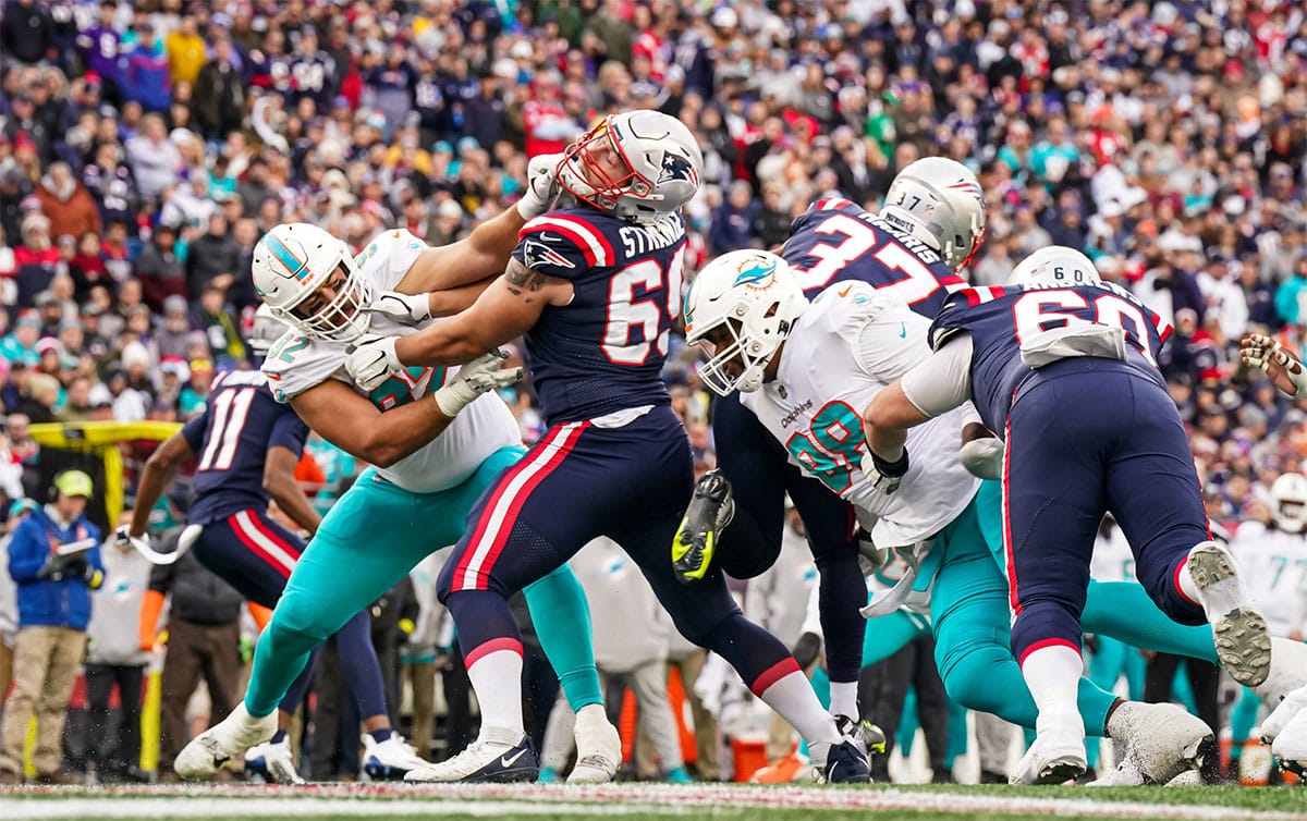 New England Patriots guard Cole Strange (69) hold off Miami Dolphins defense in the first half at Gillette Stadium.