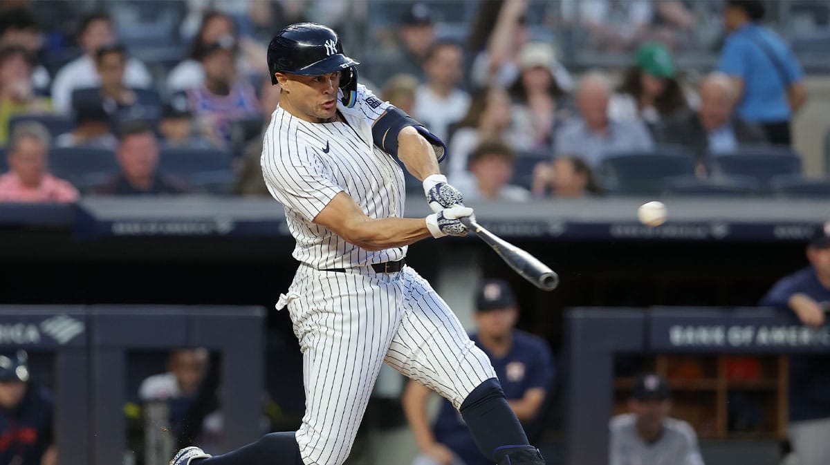 New York Yankees designated hitter Giancarlo Stanton (27) hits a solo home run against the Houston Astros during the third inning at Yankee Stadium