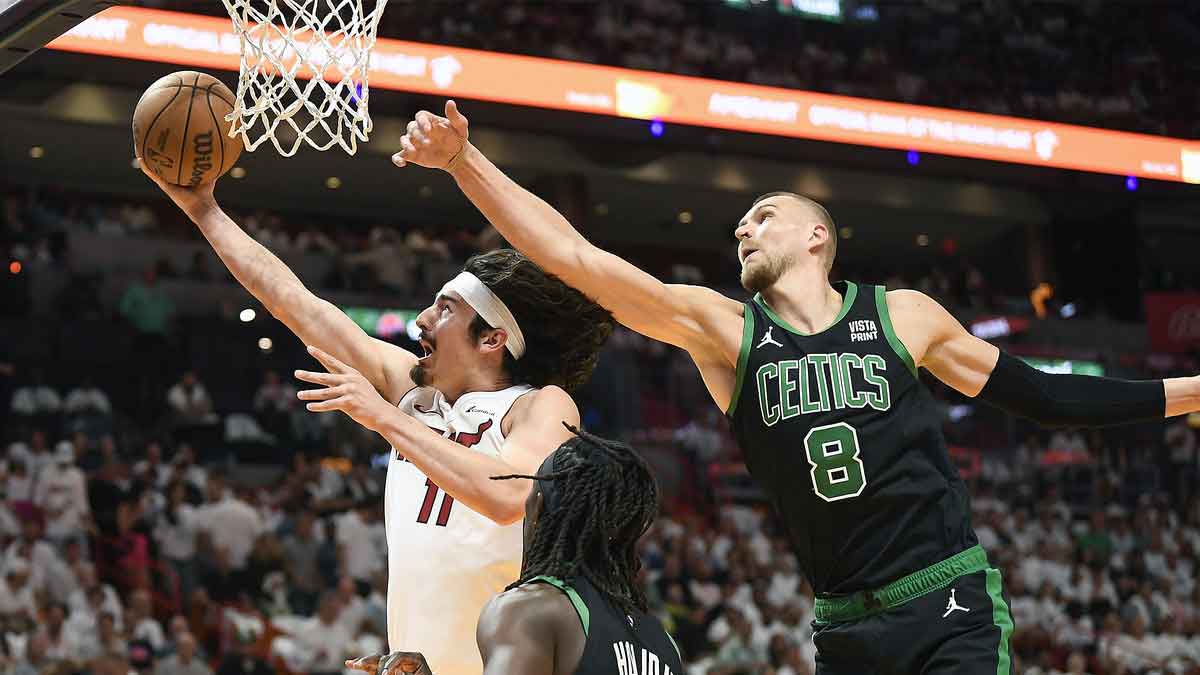 Apr 29, 2024; Miami, Florida, USA; Miami Heat guard Jaime Jaquez Jr. (11) scores in front of Boston Celtics center Kristaps Porzingis (8) during the first quarter of game four of the first round for the 2024 NBA playoffs at Kaseya Center. Mandatory Credit: Michael Laughlin-USA TODAY Sports