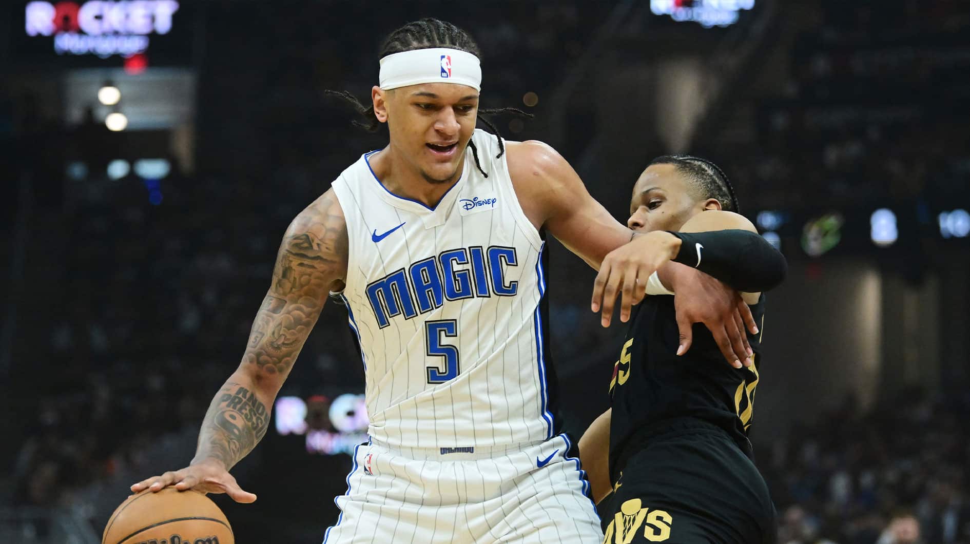 Orlando Magic forward Paolo Banchero (5) drives to the basket against Cleveland Cavaliers forward Isaac Okoro (35) during the first quarter of game seven of the first round for the 2024 NBA playoffs at Rocket Mortgage FieldHouse. 