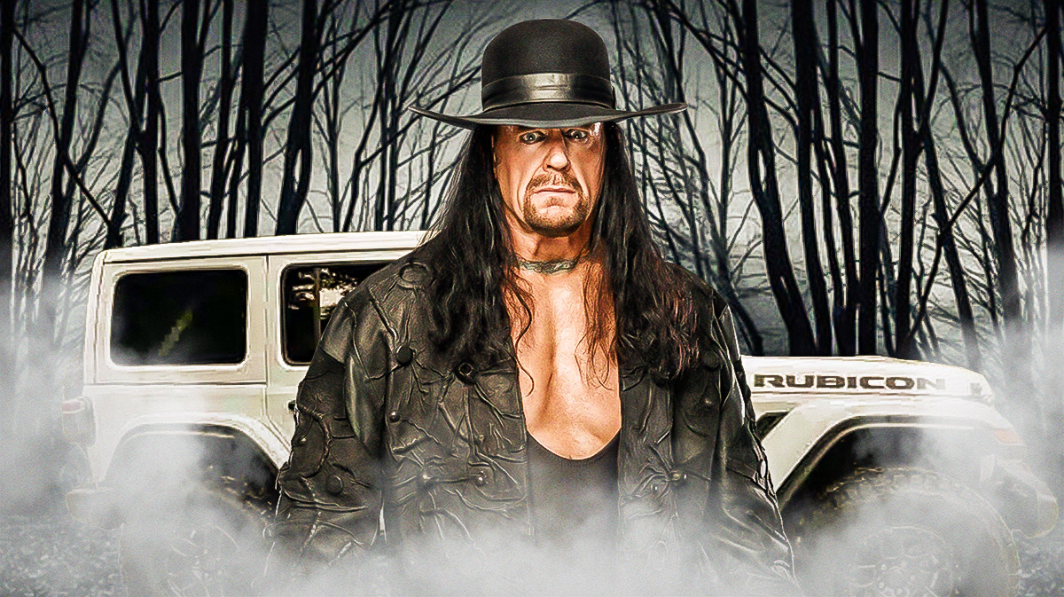 The Undertaker in front of a car from his collection.
