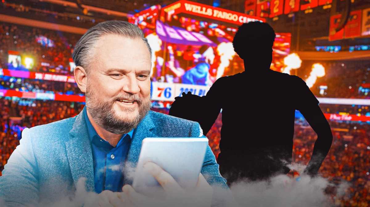 Daryl Morey on the phone looking at the blacked-out silhouette of Cameron Johnson with the Wells Fargo Center as the background.