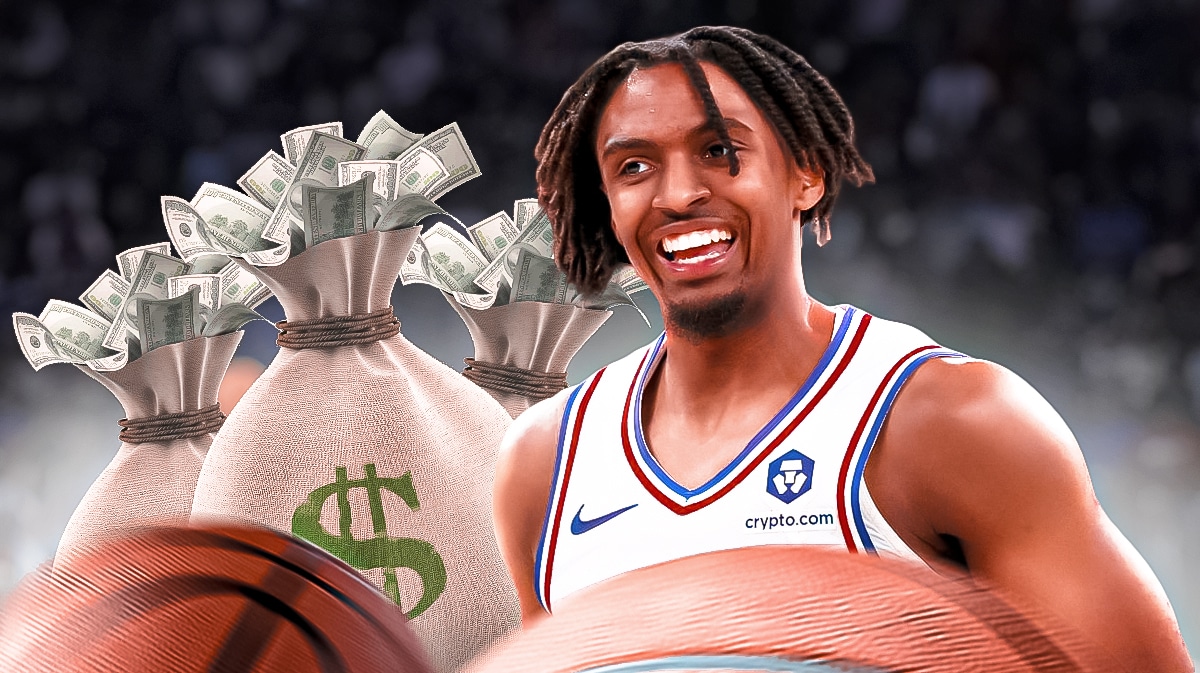 76ers' Tyrese Maxey next to bags of money