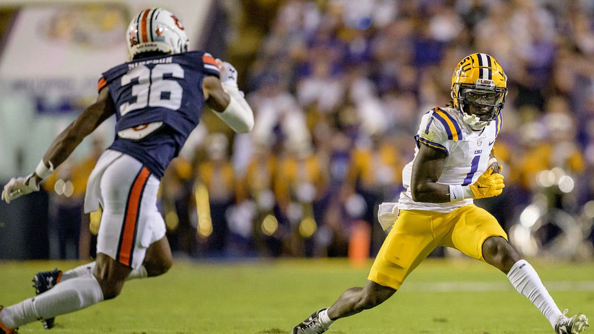 LSU Tigers wide receiver Aaron Anderson (1) runs after a reception against Auburn Tigers cornerback Jaylin Simpson (36) during the second quarter at Tiger Stadium. 