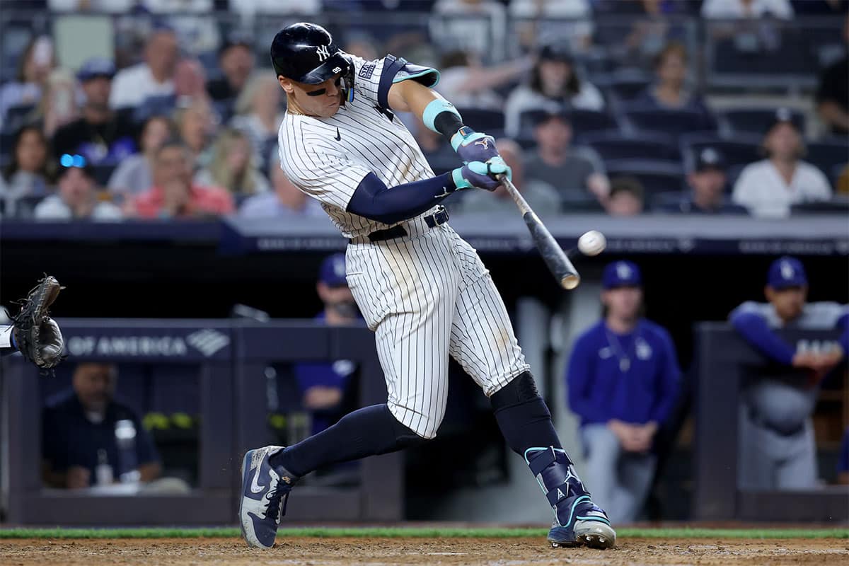New York Yankees right fielder Aaron Judge (99) hits a solo home run against the Los Angeles Dodgers during the eighth inning at Yankee Stadium. 