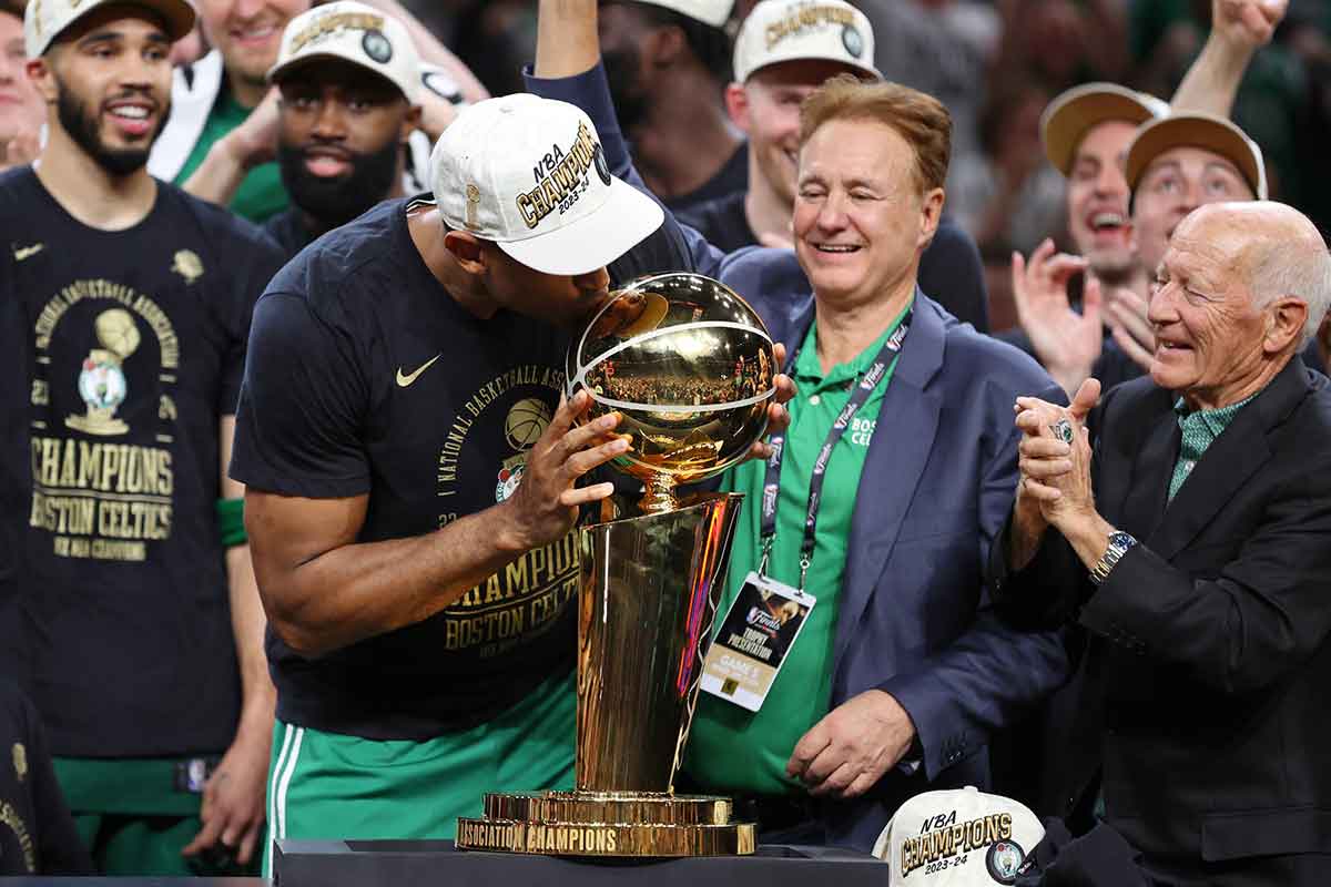Boston Celtics center Al Horford (42) kisses the trpohy after winning the 2024 NBA Finals against the Dallas Mavericks at TD Garden.
