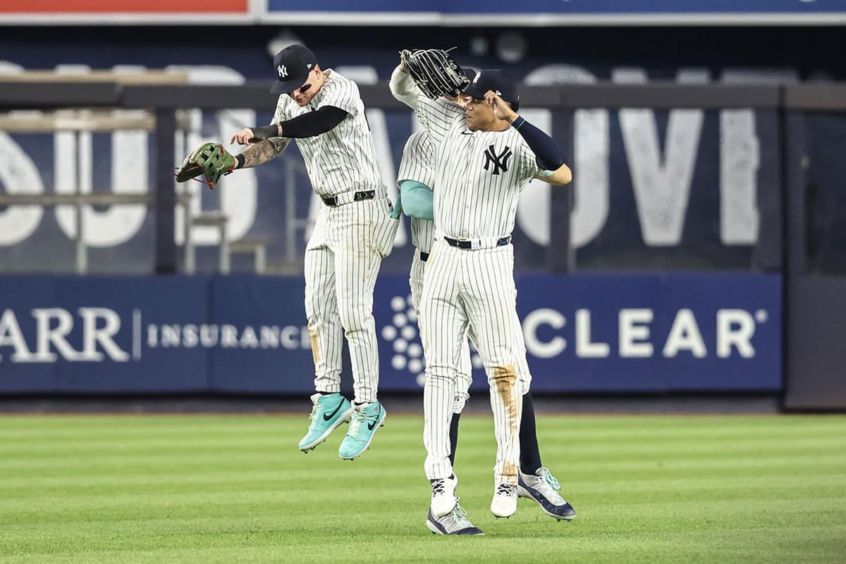 New York Yankees left fielder Alex Verdugo (24), center fielder Aaron Judge (99) and right fielder Juan Soto (22) celebrate after defeating the Atlanta Braves at Yankee Stadium. 