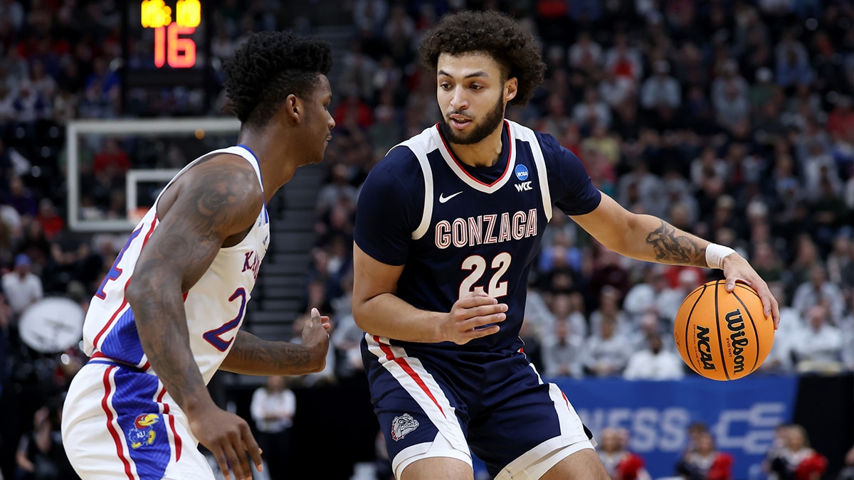 Gonzaga Bulldogs forward Anton Watson (22) dribbles against Kansas Jayhawks forward K.J. Adams Jr. (24) during the first half in the second round of the 2024 NCAA Tournament at Vivint Smart Home Arena-Delta Center.