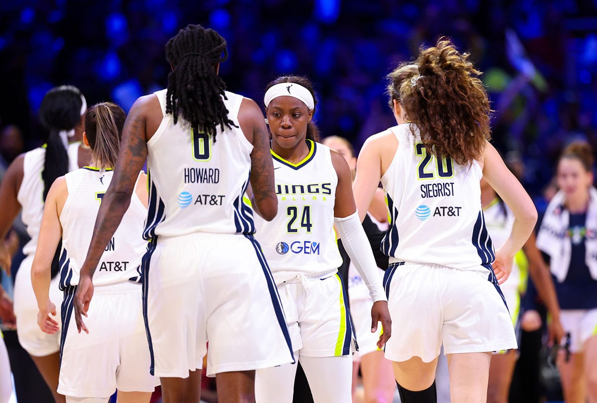 Dallas Wings guard Arike Ogunbowale (24) celebrates with Dallas Wings forward Natasha Howard (6) and Dallas Wings forward Maddy Siegrist (20) during the second half against the Chicago Sky at College Park Center.
