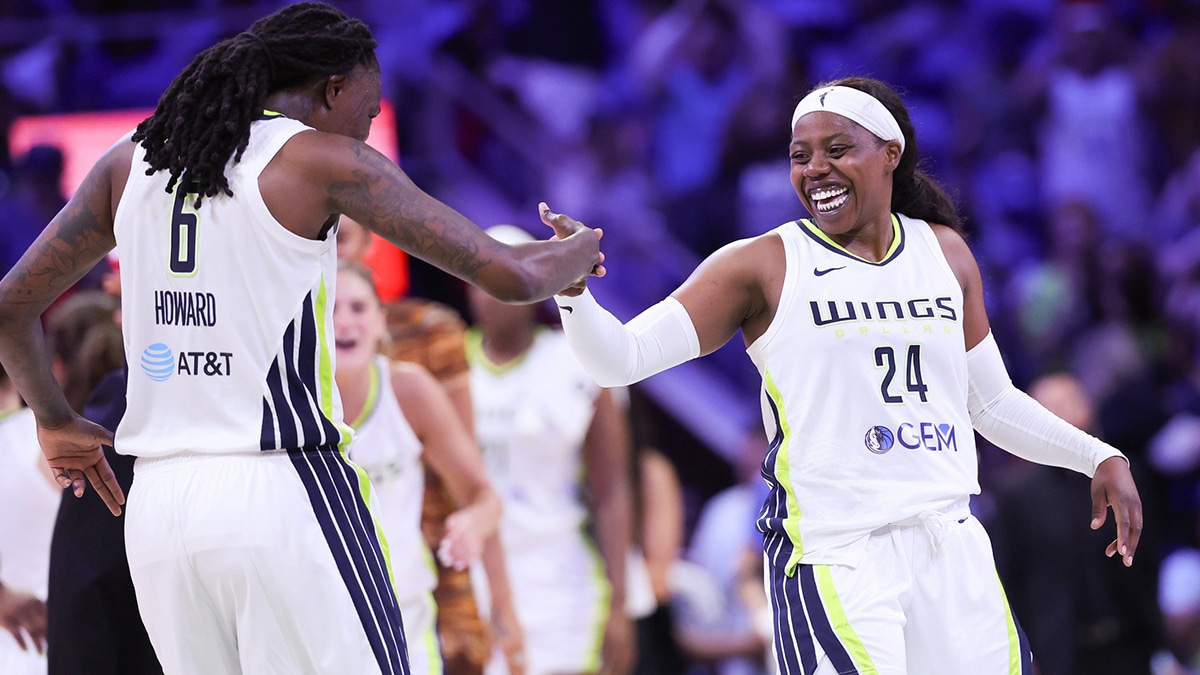Dallas Wings guard Arike Ogunbowale (24) celebrates with Dallas Wings forward Natasha Howard (6) during the second half against the Chicago Sky at College Park Center.