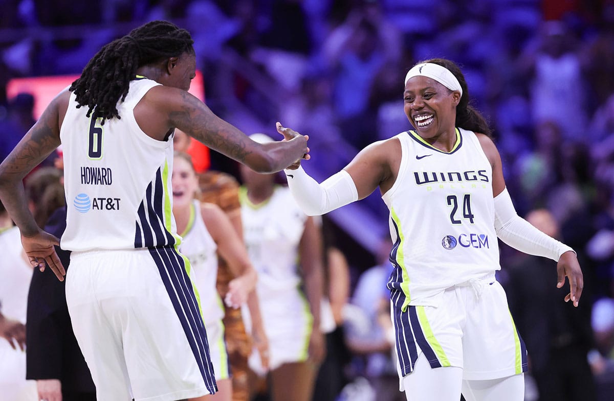 Dallas Wings guard Arike Ogunbowale (24) celebrates with Dallas Wings forward Natasha Howard (6) during the second half against the Chicago Sky.